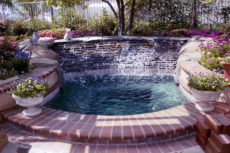 Custom Inground spa with stagggered waterfall feature